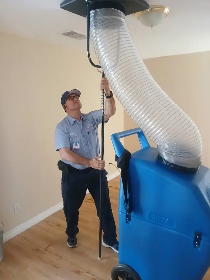 Furnace Tune-Up technician using HEPA equipment in Groveland